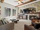 Cozy living room with a stone fireplace, wood beams, comfortable seating, and natural light at 10273 Salida St, Commerce City, CO 80022