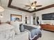 Spacious main bedroom with wood beam ceiling, ceiling fan, and large windows at 10273 Salida St, Commerce City, CO 80022