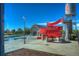 A winding red water slide stands next to a pool, offering summer fun for the community at 10273 Salida St, Commerce City, CO 80022