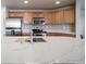 Modern kitchen with stainless steel appliances and an island with seating at 17358 Waterhouse Cir # F, Parker, CO 80134