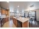 Modern kitchen with stainless steel appliances and an island with seating at 17358 Waterhouse Cir # F, Parker, CO 80134