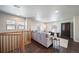 Spacious living room with gray sectional sofa and dark wood flooring at 17358 Waterhouse Cir # F, Parker, CO 80134