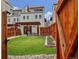 Charming fenced backyard with lush lawn, pergola-covered patio, and stylish landscaping at 613 Iowa St, Golden, CO 80403
