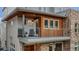 Exterior shot of furnished balcony with outdoor seating and wood and brick exterior at 613 Iowa St, Golden, CO 80403