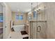 Bright bathroom featuring a soaking tub, double vanity, and modern shower at 613 Iowa St, Golden, CO 80403