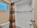 Clean bathroom featuring white tile, a shower-tub, and neutral décor at 613 Iowa St, Golden, CO 80403