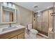 Bathroom featuring white marble vanity and glass-enclosed shower with decorative tile at 613 Iowa St, Golden, CO 80403