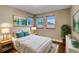 Cozy bedroom with hardwood floors, neutral walls, and abundant natural light at 613 Iowa St, Golden, CO 80403