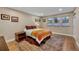Bright bedroom with three large windows, wood floors, and comfortable decor at 613 Iowa St, Golden, CO 80403