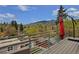 Spacious deck with outdoor umbrella and scenic mountain views in the background at 613 Iowa St, Golden, CO 80403