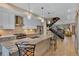 A modern kitchen with white cabinets, stainless steel appliances, and a granite island with bar seating at 613 Iowa St, Golden, CO 80403
