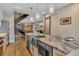 Spacious kitchen with stainless appliances, granite countertops, bar seating, and modern lighting fixtures at 613 Iowa St, Golden, CO 80403