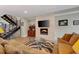 A cozy living room with modern fireplace, staircase, and contemporary furnishings at 613 Iowa St, Golden, CO 80403
