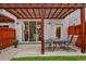 Outdoor patio with a dining set, pergola, and access to a well-maintained backyard at 613 Iowa St, Golden, CO 80403