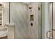 Modern shower featuring decorative tile, bronze fixtures, and a glass door at 613 Iowa St, Golden, CO 80403