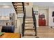 View of metal staircase, living area, and view into kitchen with stainless appliances at 613 Iowa St, Golden, CO 80403