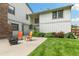 Inviting backyard featuring a fire pit, chairs, and beautiful landscaping, perfect for outdoor relaxation at 8474 E Otero Cir, Centennial, CO 80112