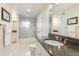 Bathroom with granite countertops, tiled shower, and frosted sliding door at 8474 E Otero Cir, Centennial, CO 80112