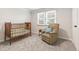 Cozy room with a crib, recliner chair, and a window with great lighting at 8474 E Otero Cir, Centennial, CO 80112