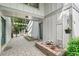 Private courtyard with brick pavers, lush plantings, and covered walkway to the front door at 8474 E Otero Cir, Centennial, CO 80112