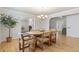 Dining room with hardwood floors and chandelier, adjacent to other living spaces at 8474 E Otero Cir, Centennial, CO 80112