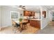 Well-lit kitchen and dining nook area with natural wood cabinetry at 8474 E Otero Cir, Centennial, CO 80112
