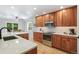 Open concept kitchen with stainless appliances and wood cabinets at 8474 E Otero Cir, Centennial, CO 80112