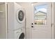 Convenient laundry room area with stacked washer and dryer near door at 8474 E Otero Cir, Centennial, CO 80112