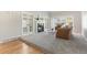 Elegant living room with a cozy fireplace, plush carpet, and double french door entry at 8474 E Otero Cir, Centennial, CO 80112