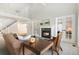 Open-concept living room with fireplace, french doors, and a view of the upper-level landing at 8474 E Otero Cir, Centennial, CO 80112