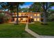 Spacious backyard with a two-level deck, lush lawn, and mature trees at 13693 W Utah Cir, Lakewood, CO 80228