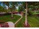 Lush backyard with mature trees, green lawn, a shed, and a patio set for outdoor enjoyment at 13693 W Utah Cir, Lakewood, CO 80228