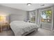 Comfortable bedroom with large windows, natural light, and views of the backyard at 13693 W Utah Cir, Lakewood, CO 80228