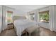 Inviting bedroom with a plush bed, neutral decor, warm lighting, and bright windows with backyard views at 13693 W Utah Cir, Lakewood, CO 80228