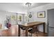 Bright dining area featuring hardwood floors, wooden table and chairs, white walls, and backyard views at 13693 W Utah Cir, Lakewood, CO 80228