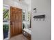 Inviting entryway with hardwood door, coat rack, and a bench at 13693 W Utah Cir, Lakewood, CO 80228