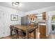 Kitchen and dining room area, featuring stainless appliances and a farmhouse dining table at 13693 W Utah Cir, Lakewood, CO 80228