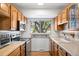 Bright kitchen featuring wood cabinets, ample counter space, and natural light at 13693 W Utah Cir, Lakewood, CO 80228