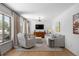 Cozy living room with hardwood floors, a comfortable couch, a chair, and a large window for natural light at 13693 W Utah Cir, Lakewood, CO 80228