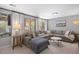 Inviting living room featuring a comfortable gray sofa, marble coffee table, and scenic outdoor views at 13693 W Utah Cir, Lakewood, CO 80228