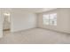 Well-lit bedroom with carpet flooring and an ensuite bathroom at 2245 Base St, Fort Lupton, CO 80621