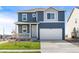 Two-story house with gray siding, white trim, and a two-car garage at 2245 Base St, Fort Lupton, CO 80621