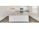 Modern kitchen with island, granite countertops, and stainless steel appliances at 2245 Base St, Fort Lupton, CO 80621