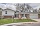 Charming split-level home with brick and siding, a well-manicured lawn, and an attached garage at 7791 S Columbine St, Centennial, CO 80122