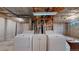 Unfinished basement area with laundry hookups and concrete walls at 8752 E Amherst Dr # D, Denver, CO 80231