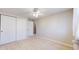 Bedroom features a window with sheer curtains, ceiling fan and closet space at 8752 E Amherst Dr # D, Denver, CO 80231