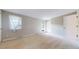 Spacious bedroom with neutral carpet, large window with sheer curtains and a door to the outside at 8752 E Amherst Dr # D, Denver, CO 80231