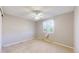 Neutral bedroom features a window with sheer curtains and a ceiling fan at 8752 E Amherst Dr # D, Denver, CO 80231