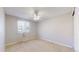 Bedroom features a window with sheer curtains and a ceiling fan at 8752 E Amherst Dr # D, Denver, CO 80231
