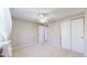 Bedroom features a window with sheer curtains, ceiling fan and closet space at 8752 E Amherst Dr # D, Denver, CO 80231
